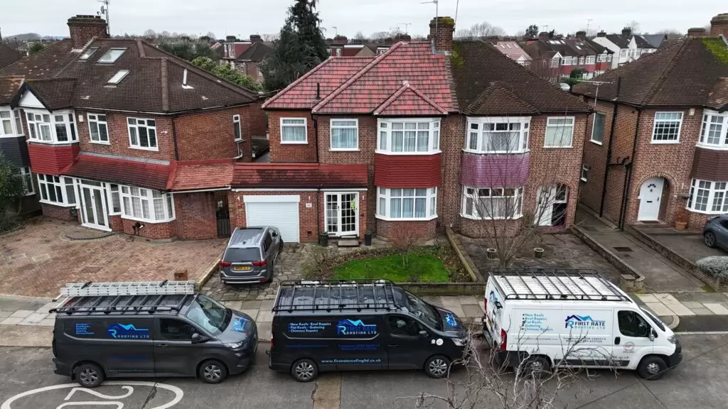 Residential street with roofing vans parked.
